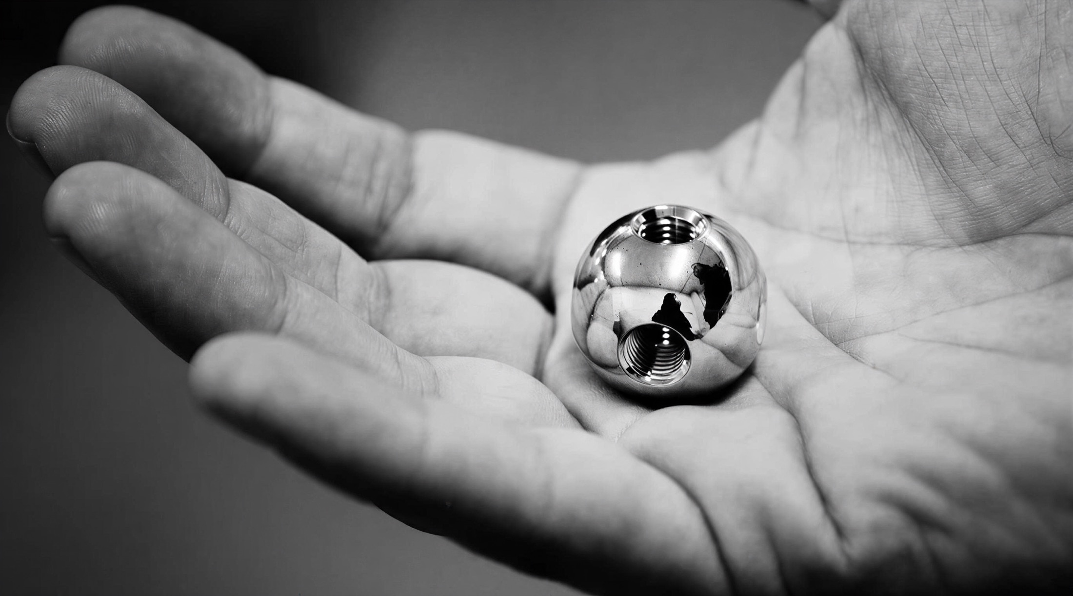 USM chrome ball joint held in a palm